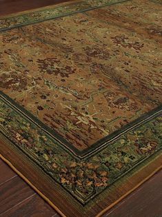 an antique rug is shown on the floor with wood floors and dark brown carpeting