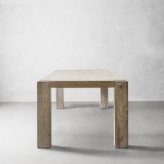 a wooden table sitting on top of a white floor