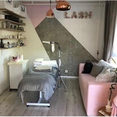 a room with a couch, table and shelves on the wall