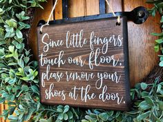 a wooden sign that says, sun little fingers touch our floor please remove your shoes at the door