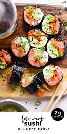 sushi on a cutting board with chopsticks next to it