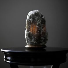 a rock sitting on top of a black table