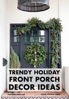 a front porch decorated for christmas with wreaths and pine cones