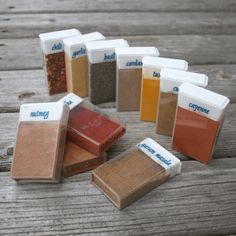 there are many different types of spices on the wooden table, including ground and salt