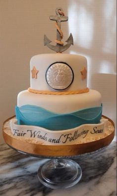 a three tiered cake with an anchor and ribbon on the top that says fair winds and falling seas