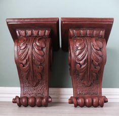 two wooden vases sitting next to each other on a table