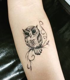 an owl tattoo on the left arm