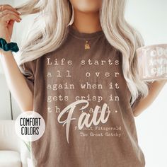 This T-shirt features a quote from The Great Gatsby and is perfect for those who love the feeling of a fresh start in the fall. The unisex garment-dyed design offers comfort and style, making it versatile for both casual and semi-formal settings. Ideal for those who enjoy autumn vibes and classic literature. Product features - Available in multiple sizes from S to 4XL for the perfect fit - Double-needle stitching for durability - Garment-dyed fabric for a soft color and texture - Made with high- Inspirational Crew Neck T-shirt For Fall, Inspirational Graphic Print T-shirt For Fall, Inspirational Cotton T-shirt For Fall, Literature Gifts, Fitzgerald Quotes, Quote Shirt, The Great Gatsby, Autumn Vibes, Comfort Colors Tee