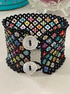 the beaded bracelet has buttons on it