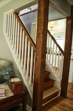 the stairs are made of wood and have white railings