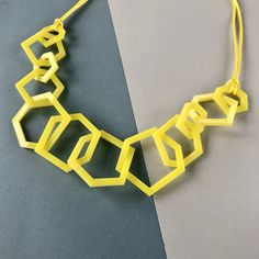 Citrus yellow chunky geometric modern statement necklace for the jewellery lover who likes simple design and colourful jewellery.  My necklaces are light and easy to wear and will give your favourite outfit an instant pop of colour. Designed using twelve laser cut perpsex shapes linked together the necklace is 24 inches long with a drop of 12 inches. There are 4 large, 4 medium and 4 small shapes measuring 2, 1.5 and 1 inch wide each. Finished with silky yellow cord and a silver plated magnetic Geometric Yellow Jewelry For Gifts, Handmade Geometric Yellow Jewelry, Colourful Jewellery, Black Tissue Paper, Yellow Jewelry, Length Necklace, Stylish Necklace, Acrylic Jewellery, Colorful Jewelry