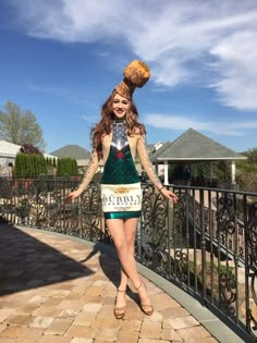 a woman in a costume is walking on a brick walkway with her hands out to the side