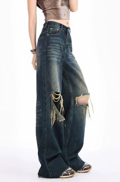 Capture the essence of edgy sophistication with our Distressed Wide-Leg Denim Jeans, perfect for those who love to blend vintage charm with modern allure. Crafted from a rich blend of cotton and polyester, these jeans feature unique raw hems and deliberate distressing for a look that's effortlessly nonchalant. The high waist design ensures comfort and style, while the wide-leg cut offers a relaxed fit that doesn't compromise functionality or flair. Pair these versatile jeans with a tucked-in gra Distressed Recycled Denim Jeans For Fall, Edgy Distressed Denim Blue Flare Jeans, Chic Ripped Jeans For Streetwear, Casual Distressed Flare Jeans In Recycled Denim, Chic Jeans With Frayed Hem For Streetwear, Chic Streetwear Jeans With Frayed Hem, Distressed Grunge Flare Jeans For Fall, Edgy Distressed Denim Blue Jeans, Trendy Baggy Distressed Flare Jeans