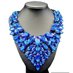 "Blue Paradise": Dare to step into the unknown and explore the depths of fashion and style with the Blue Paradise Necklace. This bold statement necklace will spice up any outfit and help you stand out with its vibrant blue color. Take the plunge and make a statement with this amazing accessory! Blue stone bib has multiple hinges which allows this necklace to move with the body. Approximately 21" with extender. Blue stone adorned bib measures about 7" long! Crown Collection, Bold Statement Necklaces, Into The Unknown, Fashion And Style, The Unknown, Vibrant Blue, Blue Stone, Spice Up, Single Piece