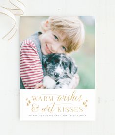 a card with a photo of a child holding a dog