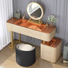 a dressing table with two stools and a mirror on the wall next to it