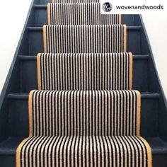 the stairs are painted black and white with striped carpeting on each side, along with a yellow border