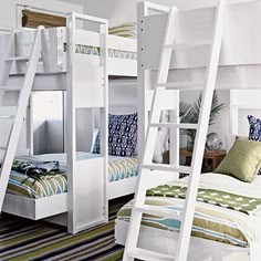 bunk beds with ladders are in a bedroom