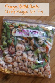 shrimp and veggie stir fry in a plastic bag on a wooden table with text overlay