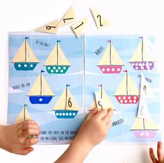 two children are playing with matching numbers and boats