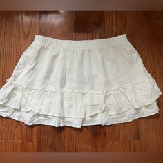 White Brandy Melville Mini Skirt -New With Tag -Flowy Tiered Mini Skirt With A Stretchy Waist Line And Ruffle Seams. -Fabrics: 100% Viscose -Measurements: 13" (33 Cm) Length, 13" (33 Cm) Waist (Stretches) Mini Flowy Skirt, Casual Summer Tennis Skirt With Ruffles, White Mini Skort With Ruffle Hem, White Ruffle Hem Mini Skort, Cotton Lined Mini Skirt For Brunch, Casual Ruffled Mini Tennis Skirt, White Skort With Ruffle Hem, Casual Flowy Ruffled Tennis Skirt, White Ruffle Hem Skort