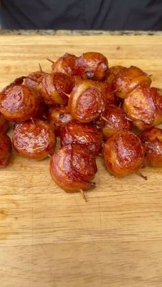 bacon wrapped in toothpicks on a wooden cutting board