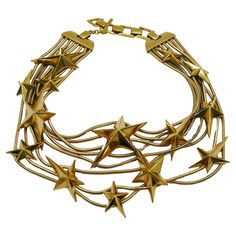 THIERRY MUGLER vintage gold tone multi strand snake chains choker necklace embellished with THIERRY MUGLER's iconic stars. Adjustable T-bar and toggle closure. Embossed THIERRY MUGLER and TM. Indicative measurements : adjustable length from approx. 32 cm (12.60 inches) to approx. 35 cm (13.78 inches). Material : Gold tone hardware. NOTES - This is a preloved vintage item, therefore it might have imperfections. - Colors may differ slightly from actual product appearance due to differences in lighting conditions. - As a buyer, you are fully responsible for customs duties, other local taxes and any administrative procedures related to imports into the country of destination. Vintage Gold Choker, Avant Garde Jewelry, Vintage Choker Necklace, Thierry Mugler, Gold Choker, Chain Choker Necklace, Cool Necklaces, Choker Necklaces, Gothic Jewelry