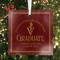 a red ornament hanging from the side of a christmas tree