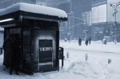 a bus stop covered in snow with the word evoket on it's side