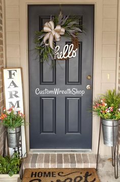 the front door is decorated with wreaths and welcome signs for customers to come home