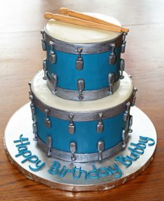 a birthday cake with blue drums on it