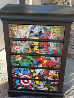 an old dresser with comic books painted on the front and sides, is shown in this image