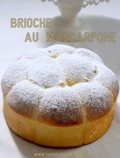 a cake with powdered sugar on top sitting in front of a white bowl and the words brioche au mascarpone