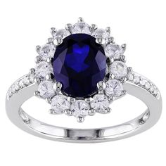 an oval blue sapphire and white topazte ring with diamonds on the sides, set in