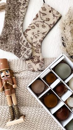 a wooden nutcracker is next to some candles and other holiday decorations on a table