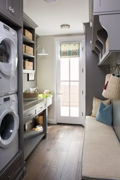 a living room filled with furniture and a washer dryer next to a door