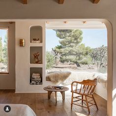 a bedroom with an open window and wooden furniture on the floor next to a bed