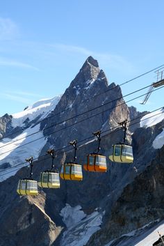 the ski lift is going up to the top of the mountain