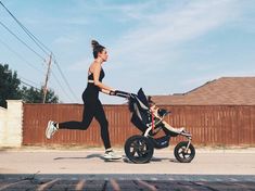 a woman jogging with her baby in a stroller