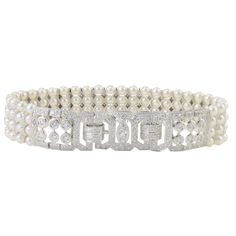 This exquisite estate bracelet features 3.50 CTW of diamonds and four strands of pearls. This 7 inch 18 karat white gold bracelet has round diamonds at approximately 3.50 carat total weight VS-SI clarity H-I color and four strands of natural Japanese pearls. This pearl and diamond bracelet is appraised at $11,300. Dimensions: 7″L x .62″H x .20″D at clasp SKU #ADTI 38 Classic White Gold Diamond Pearl Bracelet, Classic Diamond Pearl Bracelet For Formal Occasions, Elegant Pearl Bracelet With Diamond Accents, Elegant White Gold Pearl Bracelet With Diamonds, Formal Diamond Pearl Bracelet With Jubilee Style, Wedding Pearl Bracelet With Diamonds, Wedding Fine Jewelry Diamond Pearl Bracelet, Fine Jewelry Diamond Pearl Bracelet For Wedding, Wedding Diamond Pearl Bracelet In Fine Jewelry Style