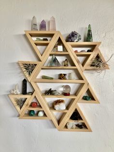 a wooden shelf filled with lots of different types of rocks