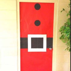 a red door decorated with black dots and a santa clause costume on it's side