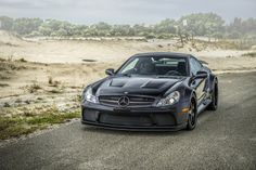 a black sports car parked on the side of a road