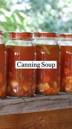 several jars filled with food sitting on top of a wooden table