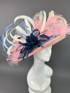 Light pink, sinamay flipped brim hat. Adorned with a navy blue feather bloom, pink peacock feathers and baby blue feathers. Attached is the Jeweled Bee. My signature mark on all of my couture pieces. Hat crown measures 22.5” with an internal elastic band to fit smaller sizes. Please measure prior to purchasing as all sales are final. Peacock Hat, Blue Feathers, Pink Peacock, Blue Feather, Rosa Pink, Peacock Feathers, Brim Hat, Elastic Band, Baby Blue