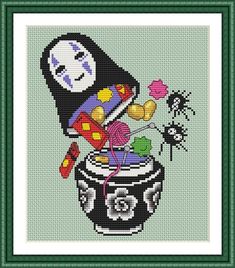 a cross stitch picture with a pot full of yarn