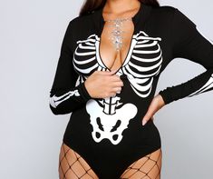 Create a stylish spooktacular look this Halloween season with this sultry bodysuit! It features a mock neckline. a zip front to create a V-neckline. long sleeves. a cheeky bottom with a dual snap button closure. and a front skeleton print. Complete your costume with chic fishnet tights and face gems for a glam vibe.Fit & Features Mock neckline Zip front Long fitted sleeves Cheeky bottom. dual snap button closure Front skeleton print Knit fabric. moderate stretch Runs true to size Halloween Costu Halloween Long Sleeve Bodysuit For Costume Party, Gothic Bodysuit For Halloween Costume Party, Halloween Long Sleeve Costume Party Bodysuit, Long Sleeve Bodysuit For Halloween Costume Party, Fitted Long Sleeve Bodysuit For Halloween, Stretch Long Sleeve Bodysuit For Costume Party, Halloween Stretch Bodysuit For Night Out, Gothic Black Bodysuit For Halloween, Black Gothic Bodysuit For Halloween