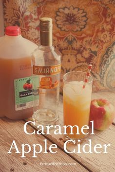 caramel apple cider with two glasses and an apple next to it on a wooden table