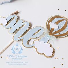 a cake topper with the word baby spelled out in gold and blue on it