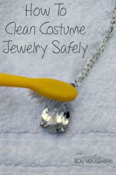 a close up of a necklace with a toothbrush on it and the words how to clean costume jewelry safely